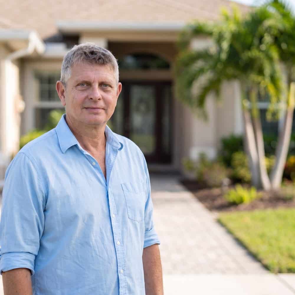 Axel Weiss, Broker at Sea to Sky Realty, at the entrance of a Bradenton home for sale