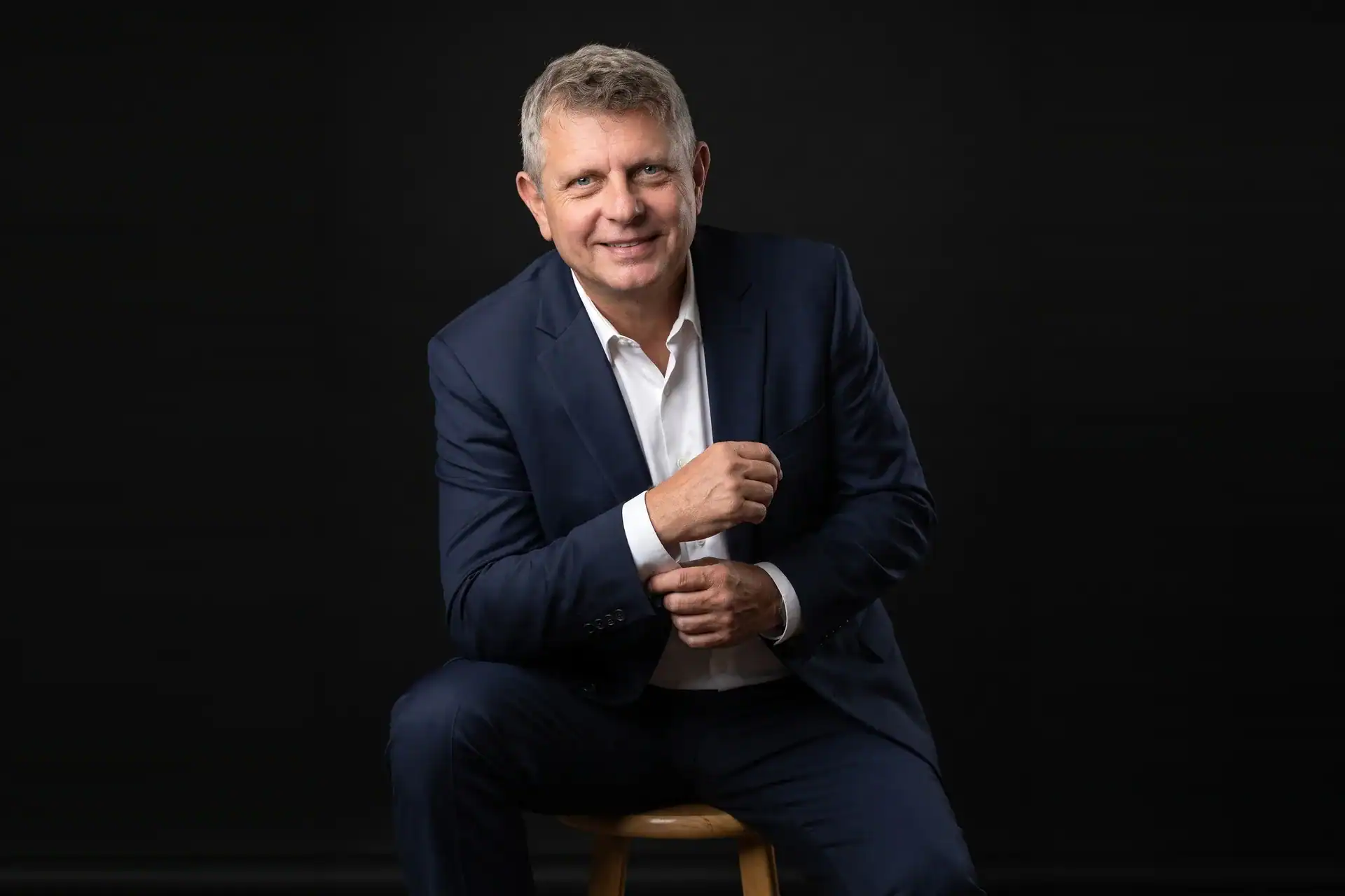 Axel Weiss, broker at Sea to Sky Realty in Bradenton, Florida — seated studio portrait