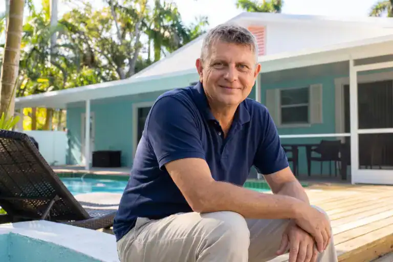Axel Weiss, broker at Sea to Sky Realty, on the pool deck of a Gulf Coast vacation home